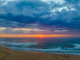 Sunrise reflections and clouds at the seaside with lagoon