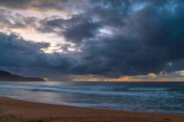 Overcast sunrise seascape with rain clouds