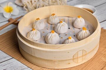 Chinese Buns or Xiaolongbao with crab meat and roe in bamboo basket. Ready for steam.