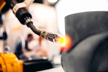 Industrial arm robot CNC automatic welding metal pipe part in factory