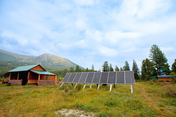 Scandinavian country cottage with solar panels surrounded by mountains, autonomous life