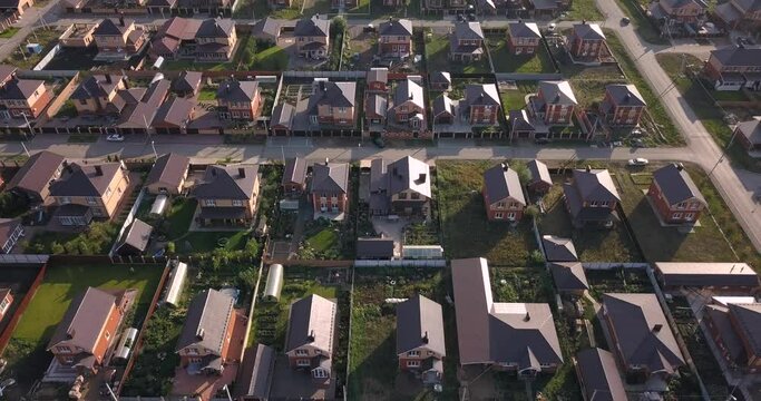 Aerial view of a luxurious village with smooth rows of two-storey duplex houses. Neighborhood in the area and real estate investments.