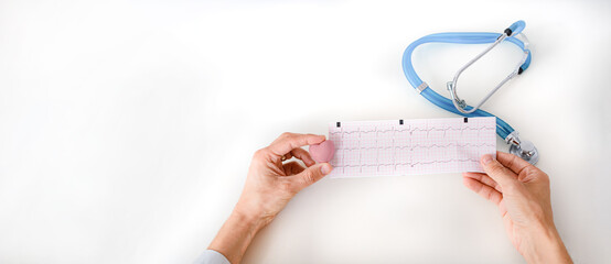Cardiologist doctor holding a heart and patient electrocardiogram