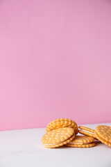 Sandwich cookies on a pink background. The concept of breakfast and a quick snack.