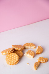Sandwich cookies on a pink background. The concept of breakfast and a quick snack.
