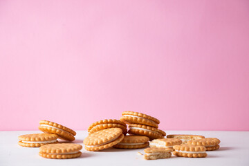 Sandwich cookies on a pink background. The concept of breakfast and a quick snack.