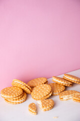 Sandwich cookies on a pink background. The concept of breakfast and a quick snack.