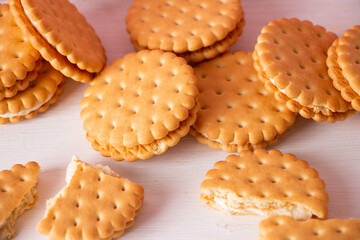 Sandwich cookies on a pink background. The concept of breakfast and a quick snack.