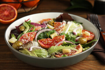 Bowl of delicious sicilian orange salad on wooden table, closeup