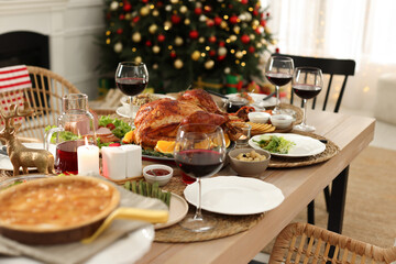 Festive dinner with delicious baked turkey served on table indoors. Christmas celebration