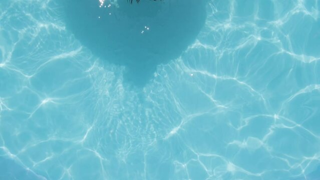 Topdown view Boy with Smartphone, Relaxing on a Floater in Swimming pool, Summer concept