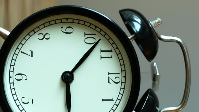 Vertical view of a jingling classic black alarm clock 
