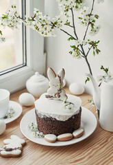 Fototapeta na wymiar Celebration and holiday. Easter cake with gingerbread, homemade cake, eggs. Easter bunny and flowering branches postcard