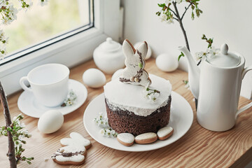 Obraz na płótnie Canvas Celebration and holiday. Easter cake with gingerbread, homemade cake, eggs. Easter bunny and flowering branches postcard