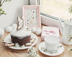 Celebration and holiday. Easter cake with gingerbread, homemade cake, eggs. Easter bunny and flowering branches postcard
