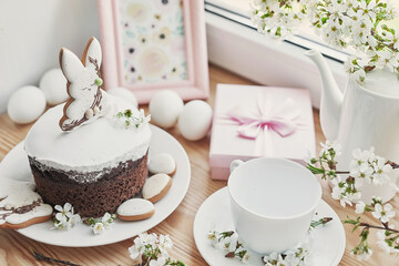 Celebration and holiday. Easter cake with gingerbread, homemade cake, eggs. Easter bunny and flowering branches postcard