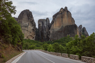 Scenic road to the towers of the Meteora conglomerate of Greece. Hiking in nature with beautiful landscapes.