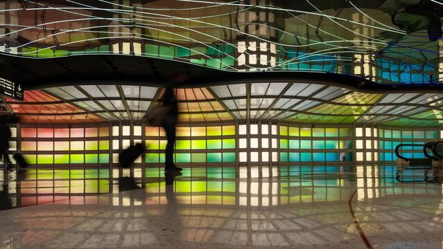 Passengers passing the illuminated tunnel at Chicago O'Hare in USA