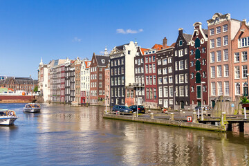 Naklejka premium Amsterdam/Holland - May 15th 2013: Amsterdam canal and famous Dutch style tall buildings