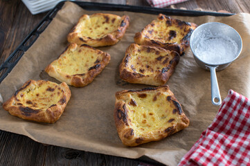 Sweet puff pastry tarts baked with sour cream, egg yolk, sugar and lemon filling
