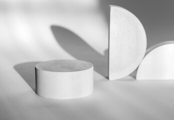 White round advertising stand with shadow. Gypsum podium for the presentation of cosmetic products. Podium plan for the presentation of cosmetic products and exhibitions