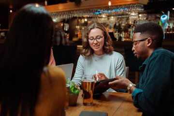 diverse colleagues out for drinks drinking beer