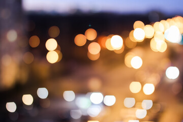 Blurred lights of the night city, colored bokeh on a dark background