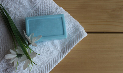 towel and soap on a wooden background there is a place for the inscription