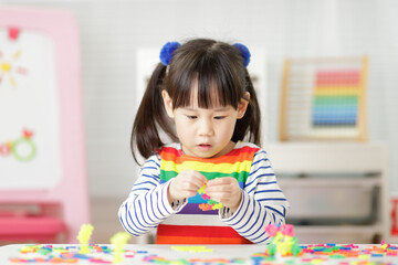 Fototapeta premium young girl playing creative blocks for homeschooling