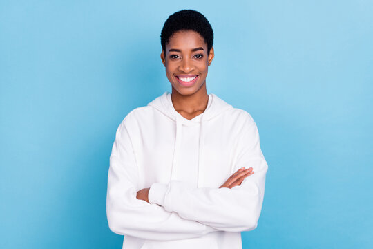 Photo of beautiful shiny trans girl wear white sweatshirt arms folded isolated blue color background