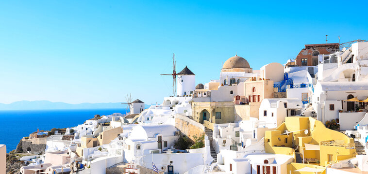 Banner travel in Santorini, Greece. Picturesq view of traditional cycladic Santorini houses with blue skyline background
