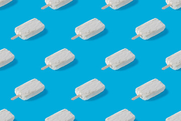 Repeating pattern of white creamy ice cream on a blue background
