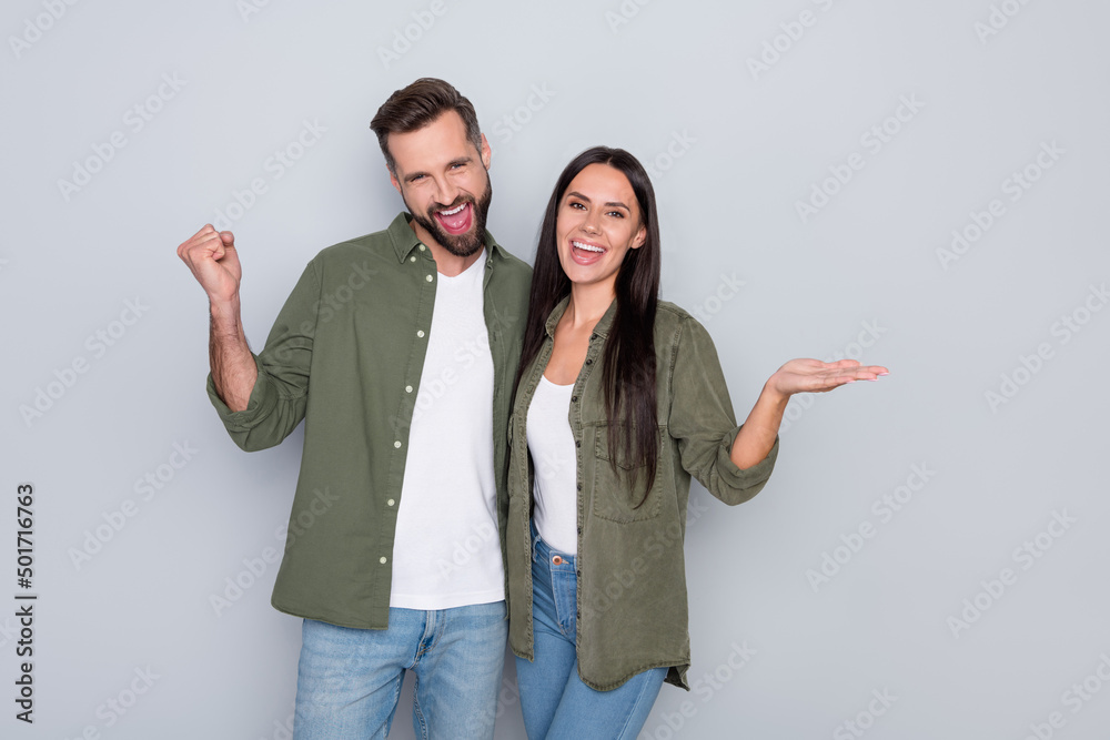 Poster Photo of young excited couple rejoice success discount product promotion isolated over grey color background