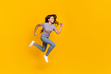 Fototapeta na wymiar Full size profile side photo of young girl jump runner motion rush speed look empty space isolated over yellow color background