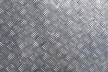 Surface of gray metal corrugated stainless steel sheet. There are traces of use, dirt and...