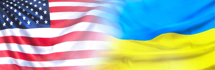US and Ukraine flags on sky background. Copy space.