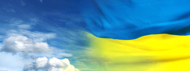 Ukraine flag on sky background. Copy space.