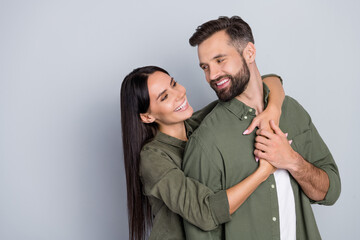 Portrait of attractive cheerful couple friends hugging romance honey moon care isolated over grey...
