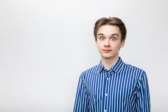 Amazed Young Man With Eyes Wide Open Studio Shot On Gray Background