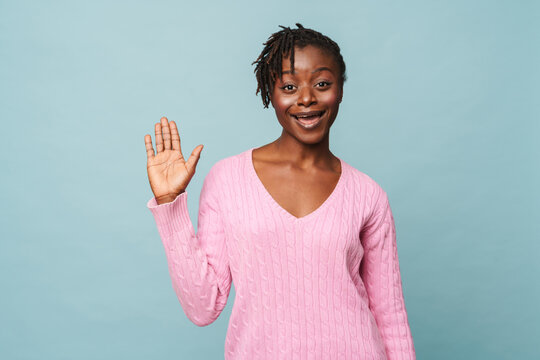 African american woman smiling and doing welcoming gesture with hand