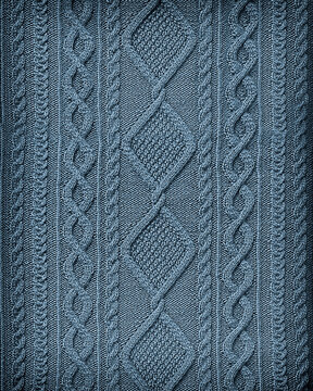 blue background texture patterned knitted fabric closeup. Embossed knitted arana pattern
