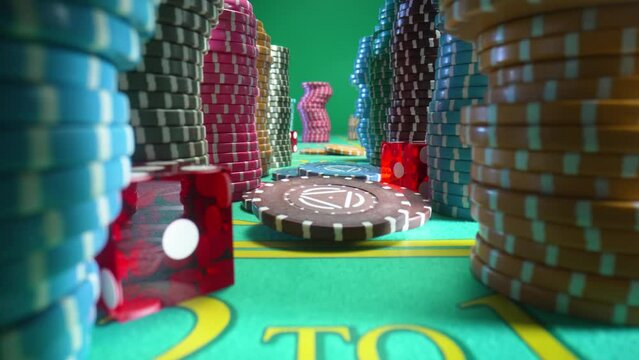 Camera pans over a gaming table with stacks of casino chips and red dice in green screen chroma key background. Game table for gambling, poker, blackjack in casino. Close up.