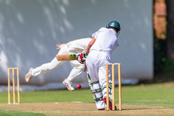 Cricket Batsman Plays Ball Bowler Action Close-Up Photo Action. - obrazy, fototapety, plakaty