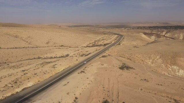 Aerial view of car driving through the Negev desert (nearby Sde Boker kibbutz), transportation and travel in South Israel
