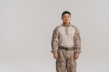 Asian military man wearing uniform posing and looking at camera