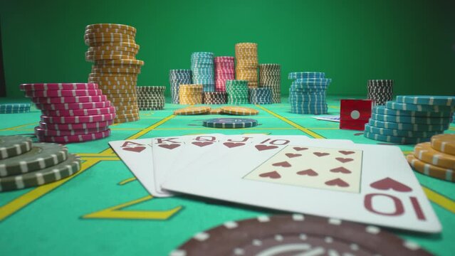Camera pans over gaming table with casino chips, cards and dice in green screen chroma key background. Royal Street Flush card combination close up. Game table for gambling, poker, blackjack in casino