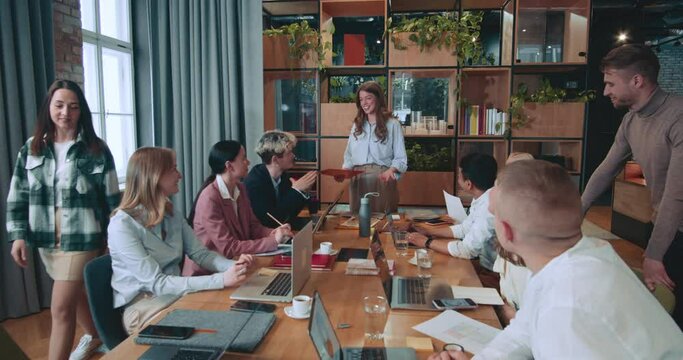 Young beautiful successful female team leader, executive businesswoman gives presentation work meeting at modern office.