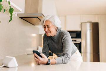 Senior woman talking to a virtual assistant on her smart speaker