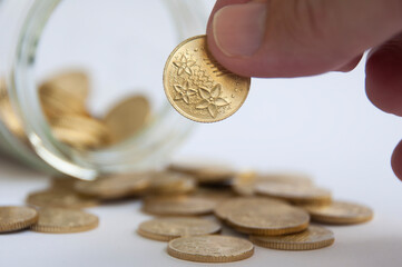 Hand holding gold coin. Business and copy space concept