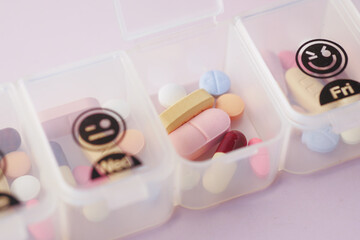 close up of medical pills in a pill box on table 